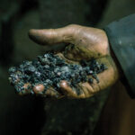 A man holding coal