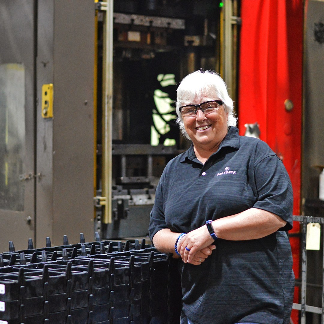 A Polydeck employee at a factory smiling