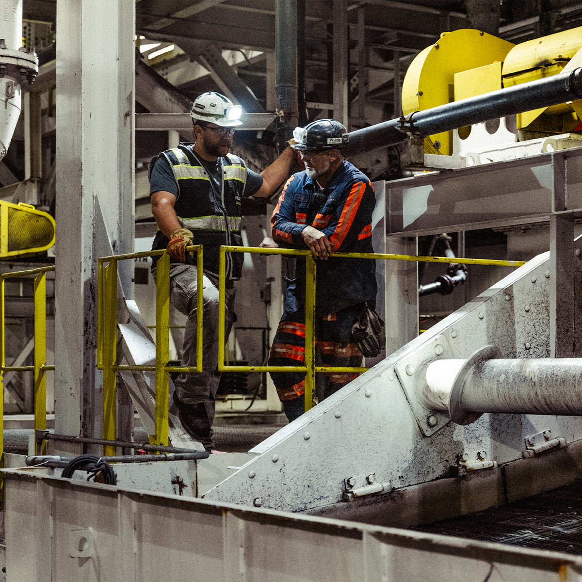 Two workers talking in an industrial facility